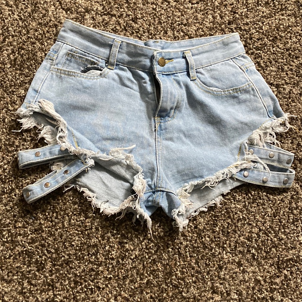 Super unique Jean shorts with strap side design.